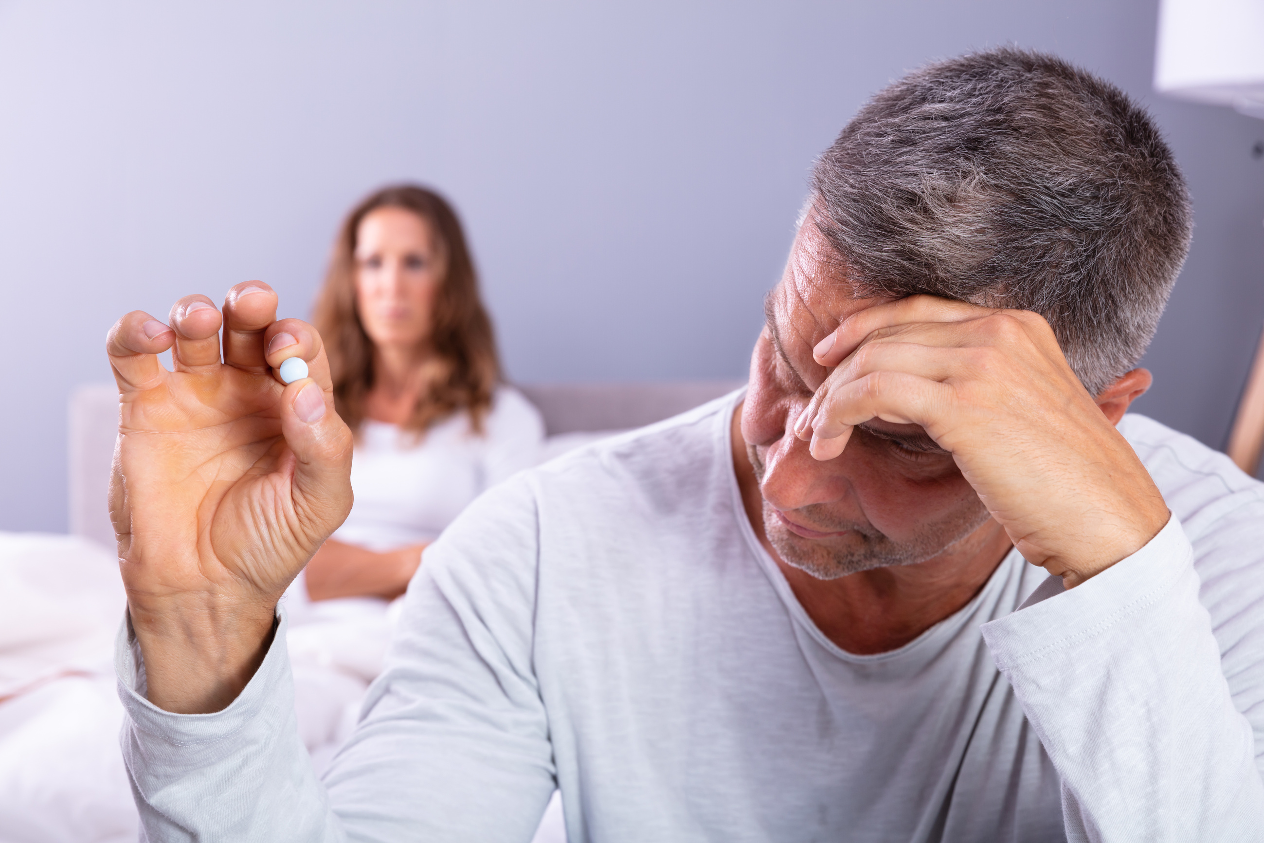 Man Suffering From Erectile Dysfunction Holding Pill In Hand